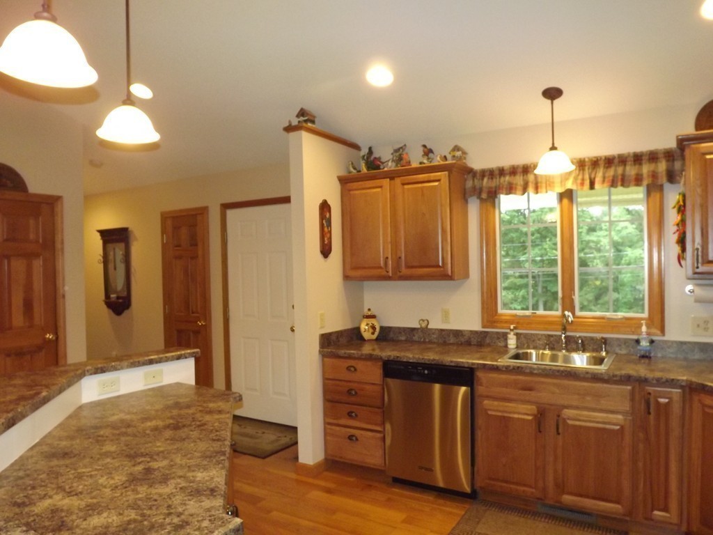 78 Bogan Road Monson, MA 01057 - Photo 5 of 20 a kitchen with stainless steel appliances granite countertop a sink a stove and a wooden floors