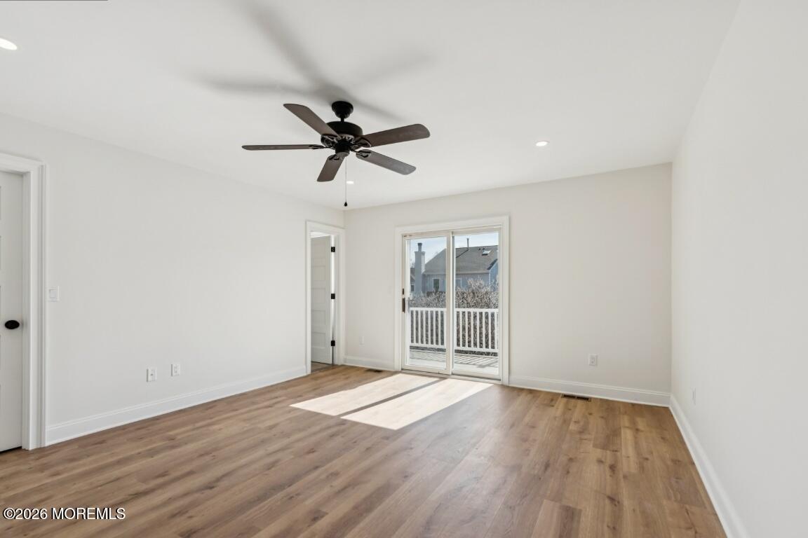 16 Shore Drive Long Branch, NJ 07740 - Photo 18 of 26 an empty room with wooden floor and windows