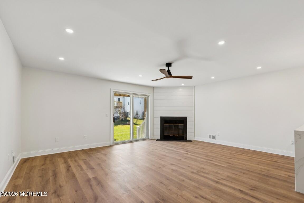 16 Shore Drive Long Branch, NJ 07740 - Photo 4 of 26 a view of empty room with a fireplace and wooden floor