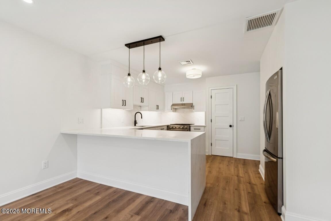 16 Shore Drive Long Branch, NJ 07740 - Photo 6 of 26 a kitchen with stainless steel appliances a refrigerator and a stove top oven