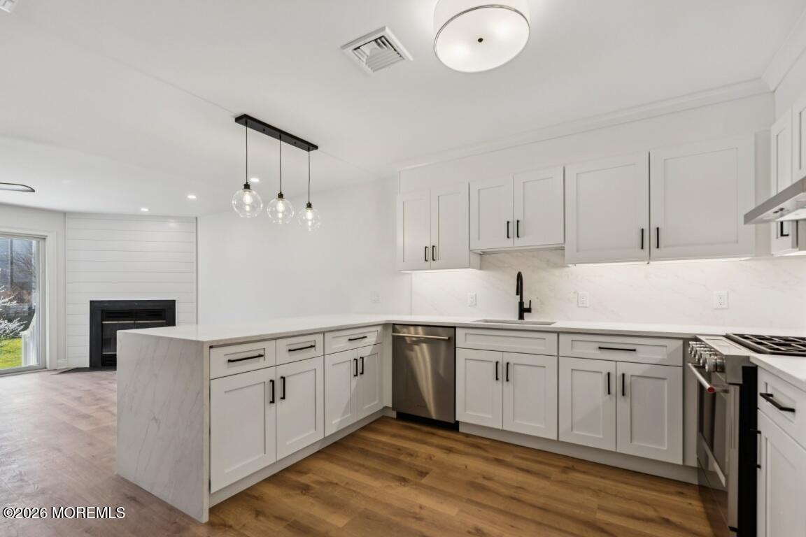 16 Shore Drive Long Branch, NJ 07740 - Photo 8 of 26 a kitchen with stainless steel appliances granite countertop a sink a stove and a refrigerator