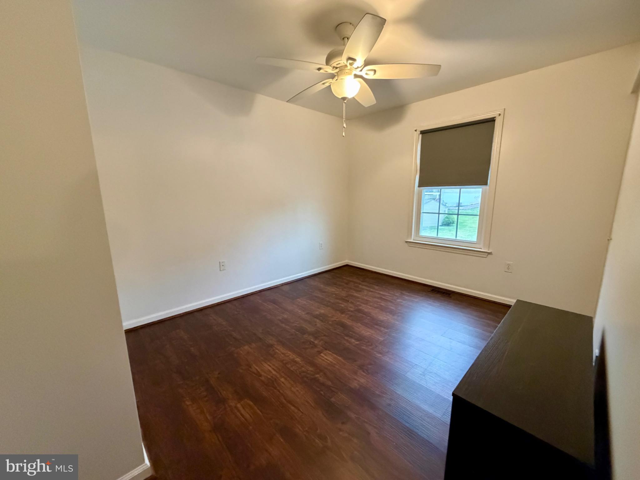 812 Kinross Avenue York, PA 17402 - Photo 19 of 29 an empty room with wooden floor and windows