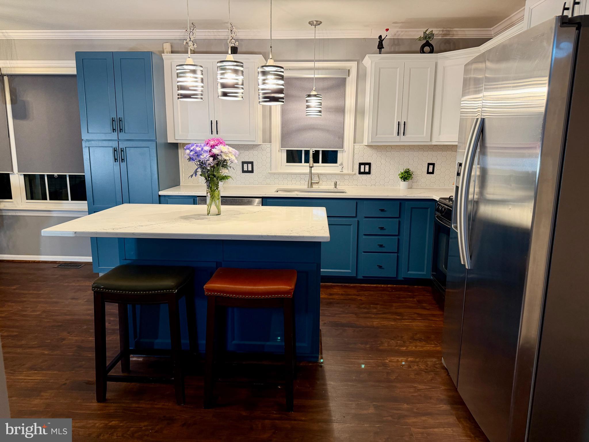812 Kinross Avenue York, PA 17402 - Photo 2 of 29 a kitchen with stainless steel appliances wooden floor sink and cabinets