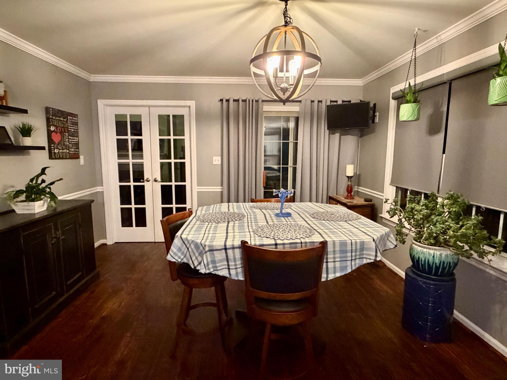 812 Kinross Avenue York, PA 17402 - Photo 4 of 29 a view of a dining room with furniture a chandelier and wooden floor
