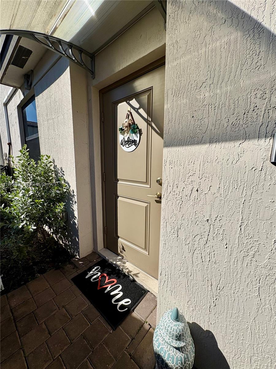 a view of a entryway door front of a house