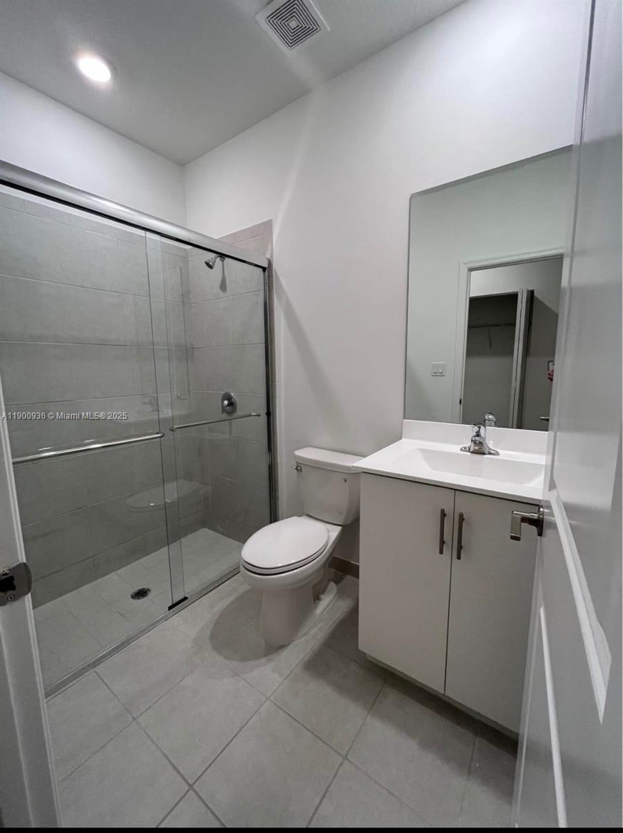 12950 Southwest 229th Lane, Unit 12950 Miami, FL 33170 - Photo 7 of 12 a bathroom with a sink toilet and shower