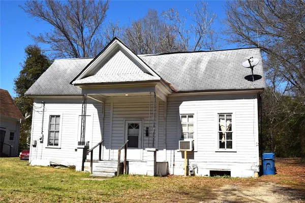 a view of house with yard