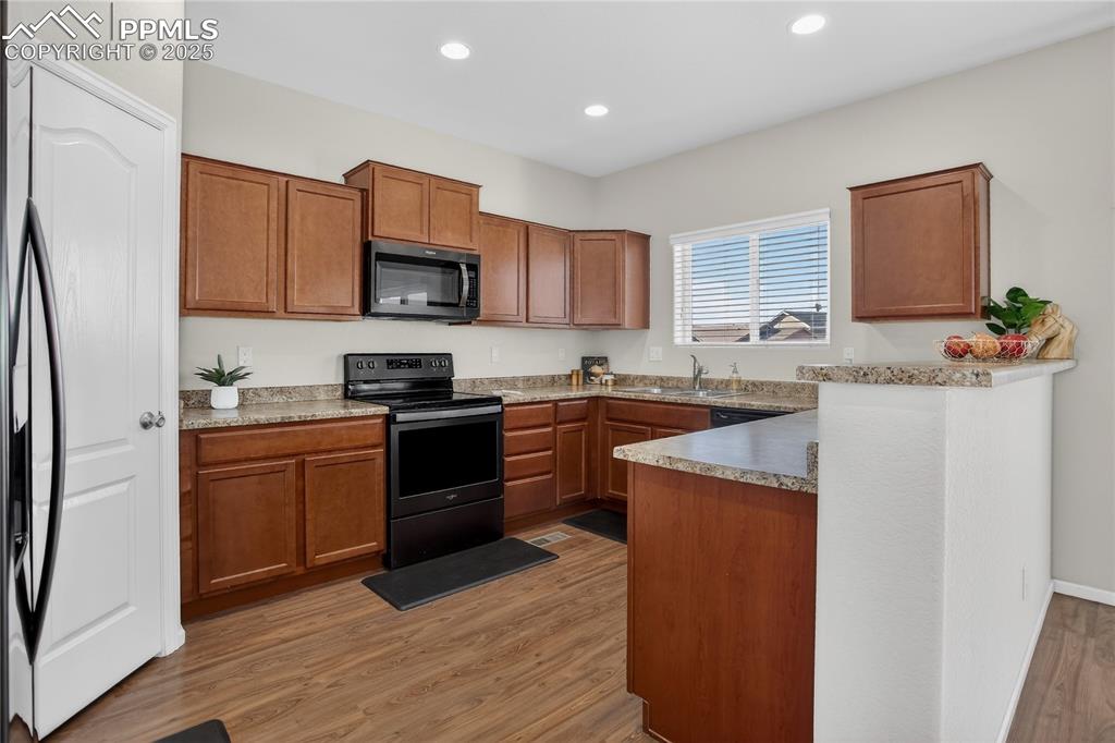 10179 Intrepid Way Colorado Springs, CO 80925 - Photo 6 of 20 Kitchen w/ breakfast bar