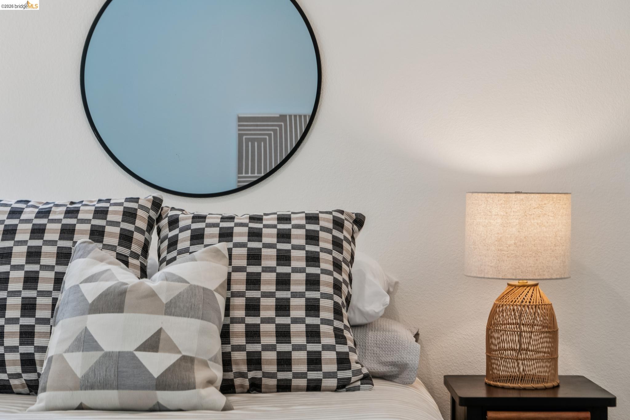 24157 Amaranth Loop Hayward, CA 94541 - Photo 44 of 63 White wall with a circular mirror featuring a black frame