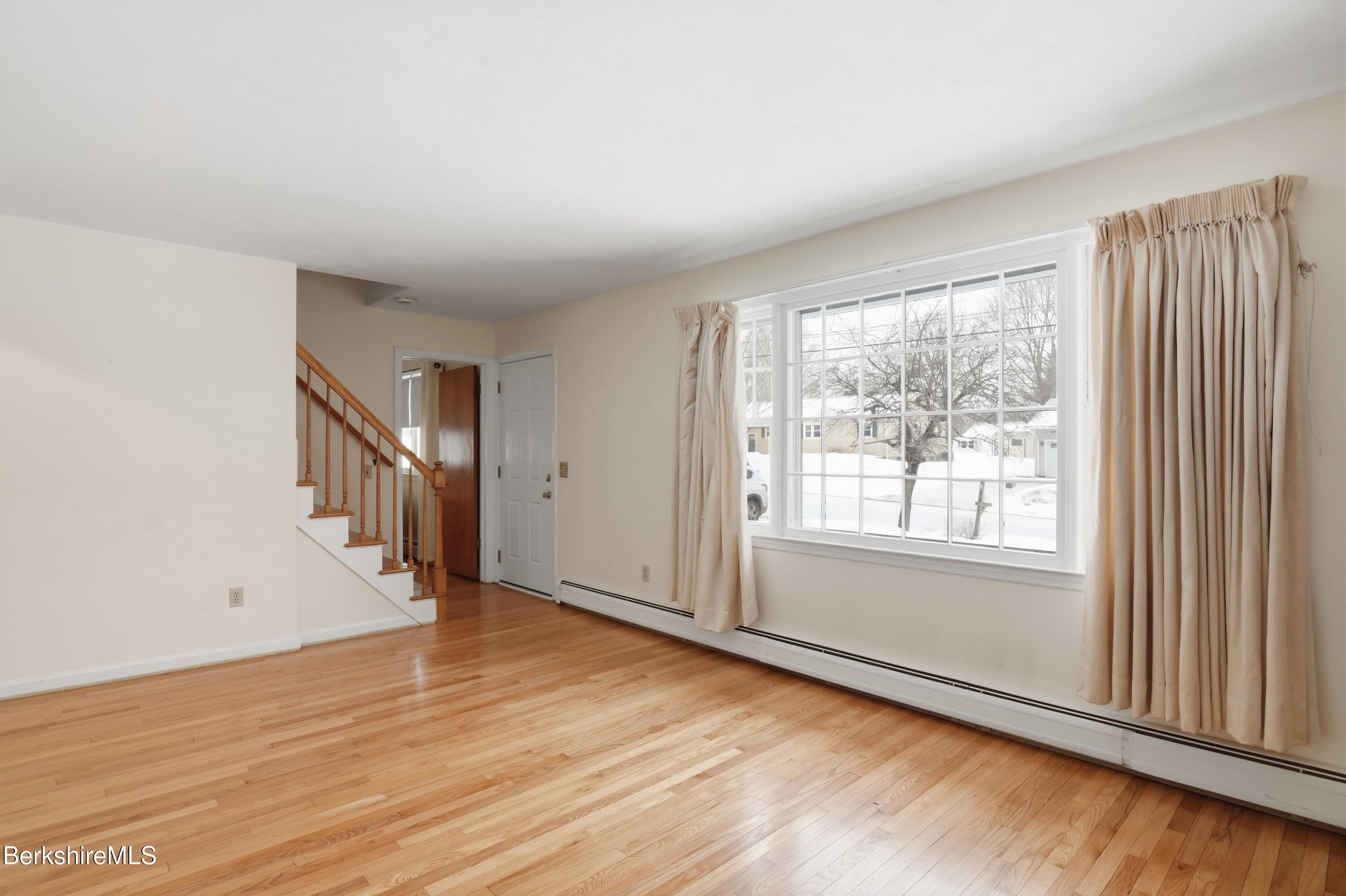 82 Quirico Drive Pittsfield, MA 01201 - Photo 13 of 30 a view of an empty room with wooden floor and a window