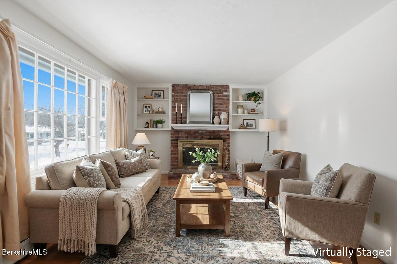 82 Quirico Drive Pittsfield, MA 01201 - Photo 15 of 30 a living room with furniture a rug and a fireplace