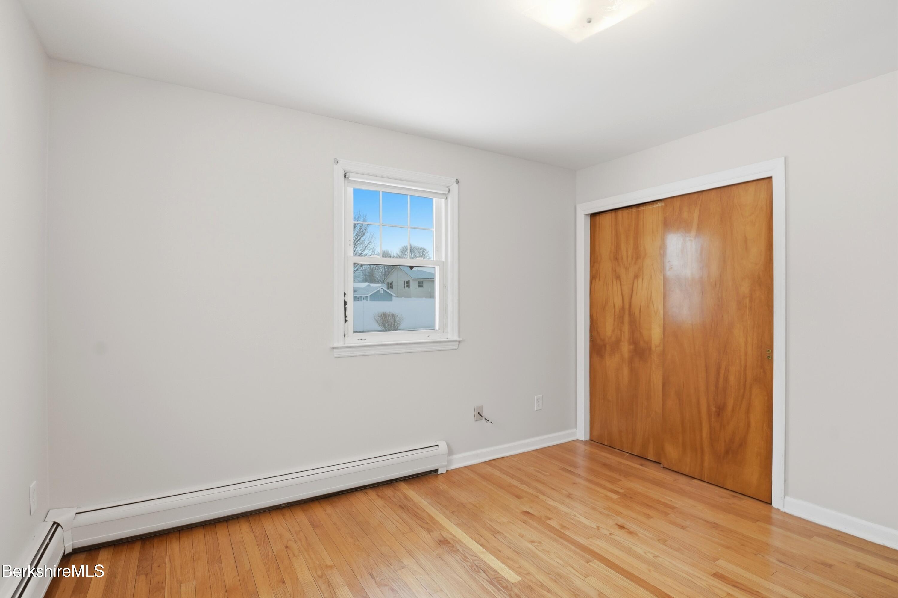 82 Quirico Drive Pittsfield, MA 01201 - Photo 17 of 30 an empty room with wooden floor and windows