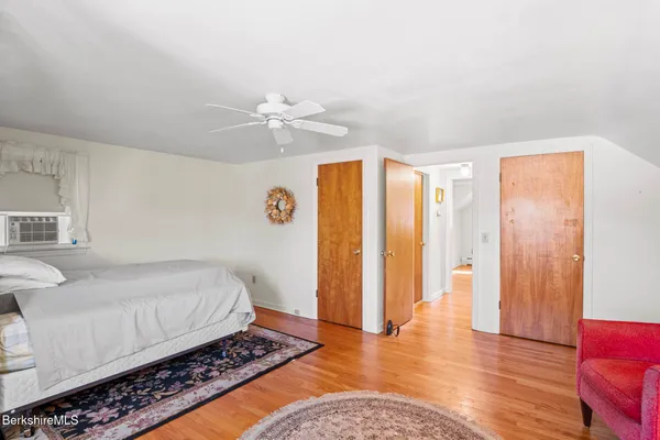 a bedroom with a bed dresser and a window