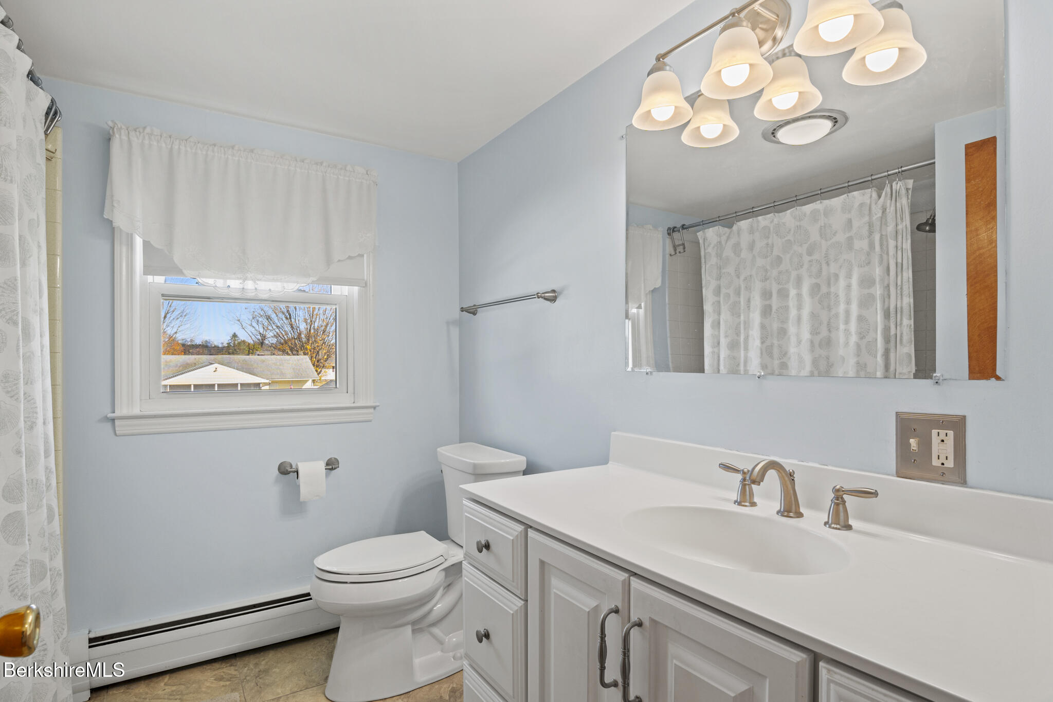 82 Quirico Drive Pittsfield, MA 01201 - Photo 24 of 30 a bathroom with a sink a toilet and a mirror