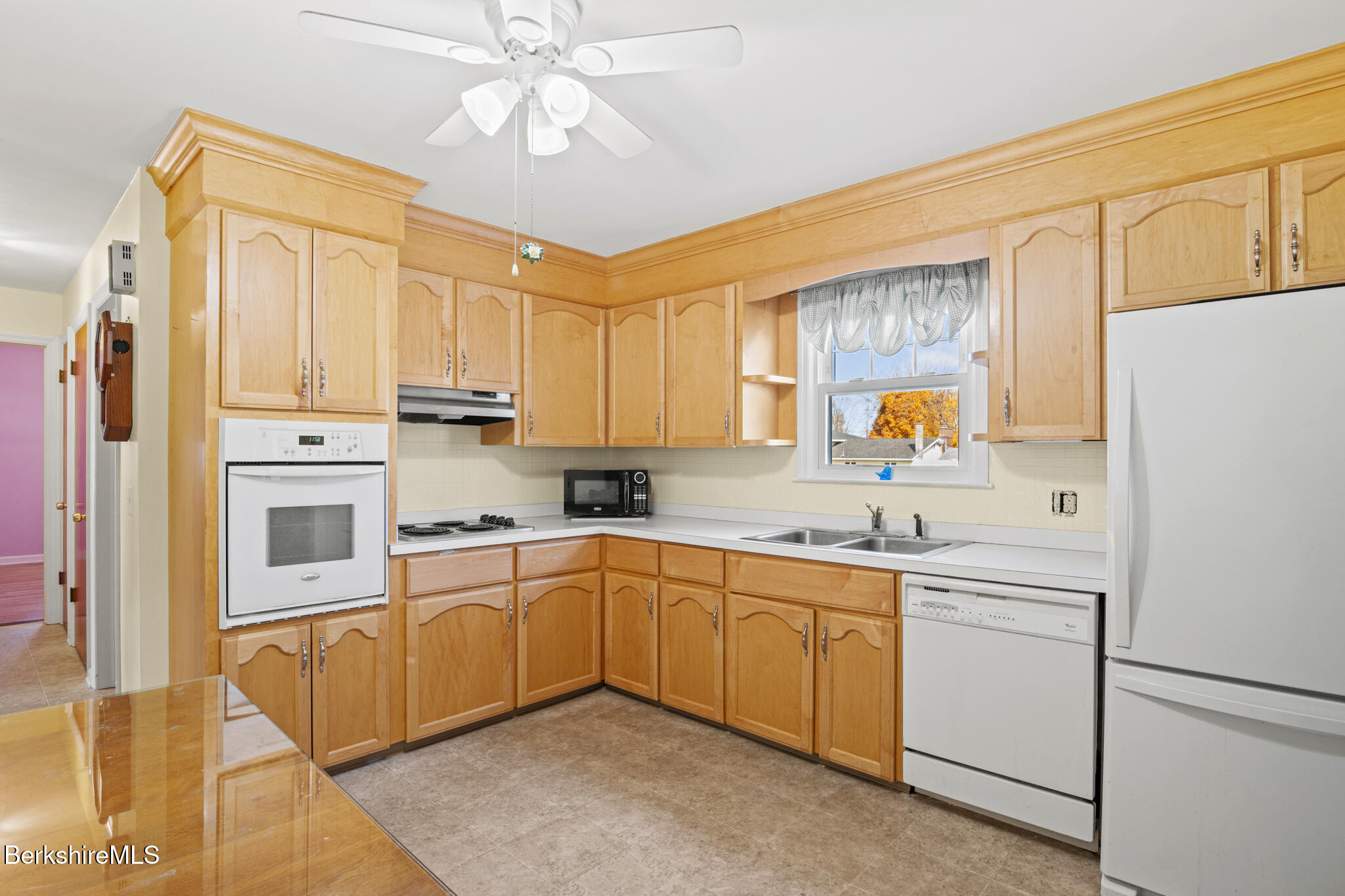 82 Quirico Drive Pittsfield, MA 01201 - Photo 4 of 30 a kitchen with a sink cabinets stainless steel appliances and a window