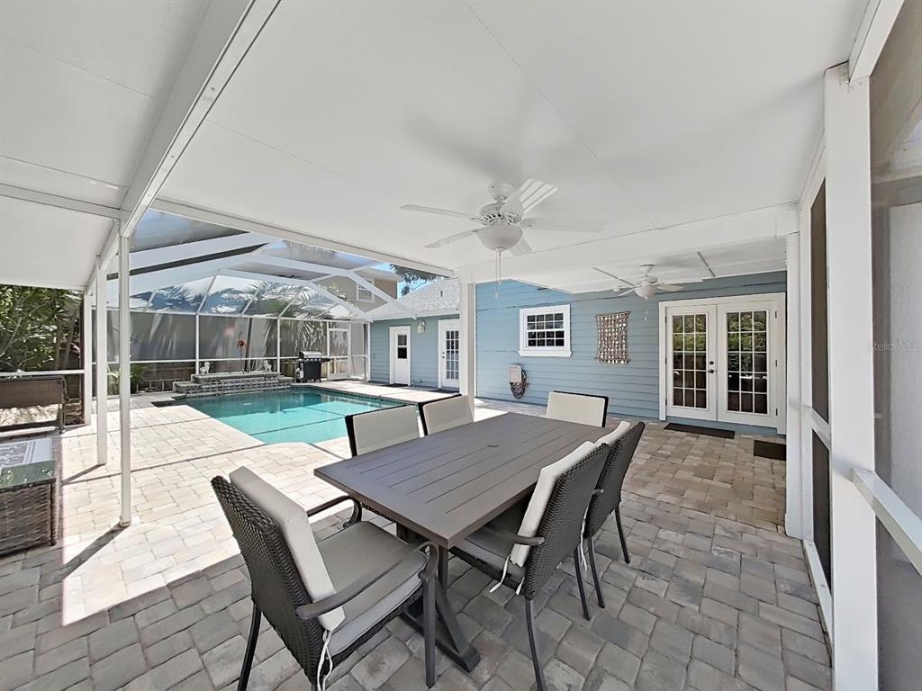 7645 Harborview Way Seminole, FL 33776 - Photo 40 of 55 a view of a patio with a table and chairs