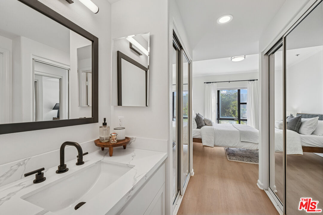 290 North Hudson Avenue, Unit 403W Pasadena, CA 91101 - Photo 11 of 25 a en suite bathroom with a double vanity sink and mirror