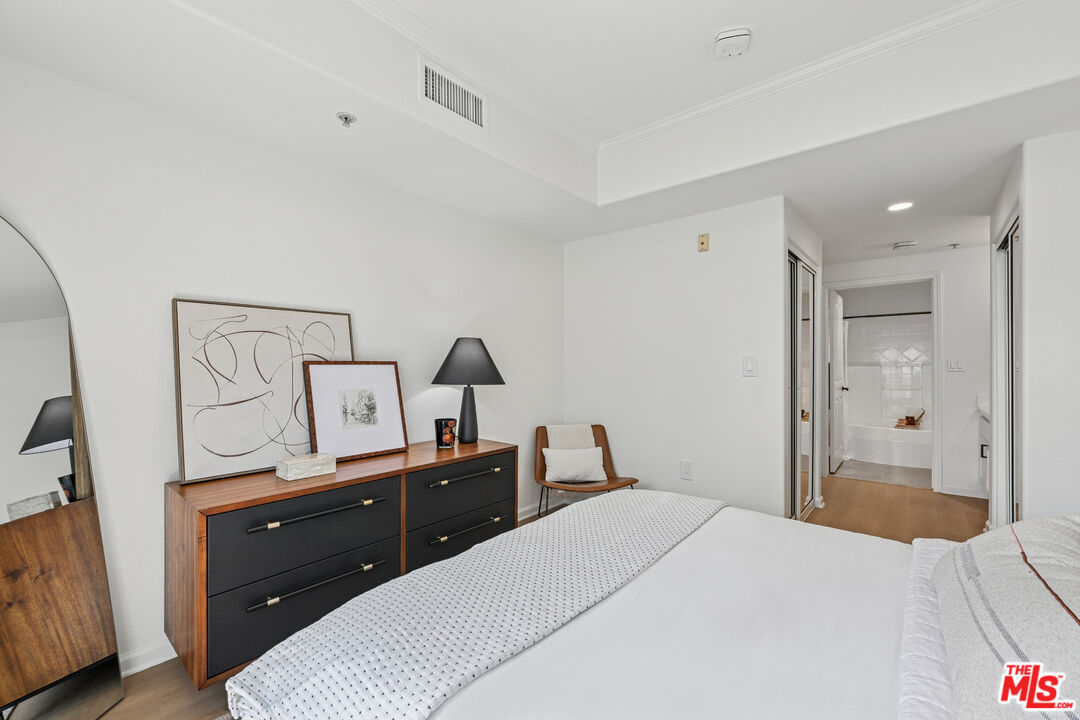 290 North Hudson Avenue, Unit 403W Pasadena, CA 91101 - Photo 12 of 25 a bedroom with a bed and a flat tv screen on dresser