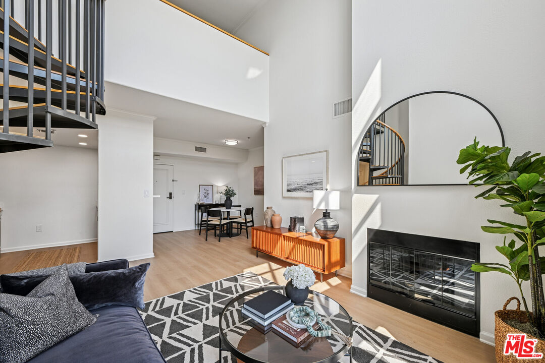 290 North Hudson Avenue, Unit 403W Pasadena, CA 91101 - Photo 15 of 25 a living room with furniture a flat screen tv and a fireplace