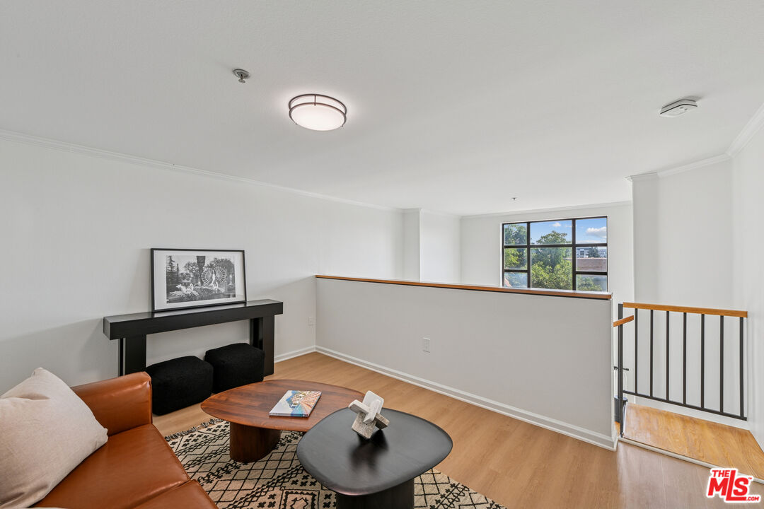 290 North Hudson Avenue, Unit 403W Pasadena, CA 91101 - Photo 17 of 25 a living room with furniture and a wooden floor