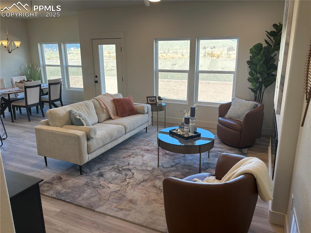 817 Keystone Loop Canon City, CO 81212 - Photo 6 of 19 Living room with light wood-style flooring and a chandelier