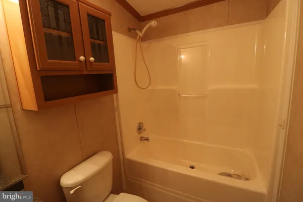 a bathroom with a shower and toilet