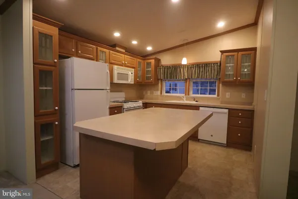 a kitchen with a refrigerator a sink and cabinets