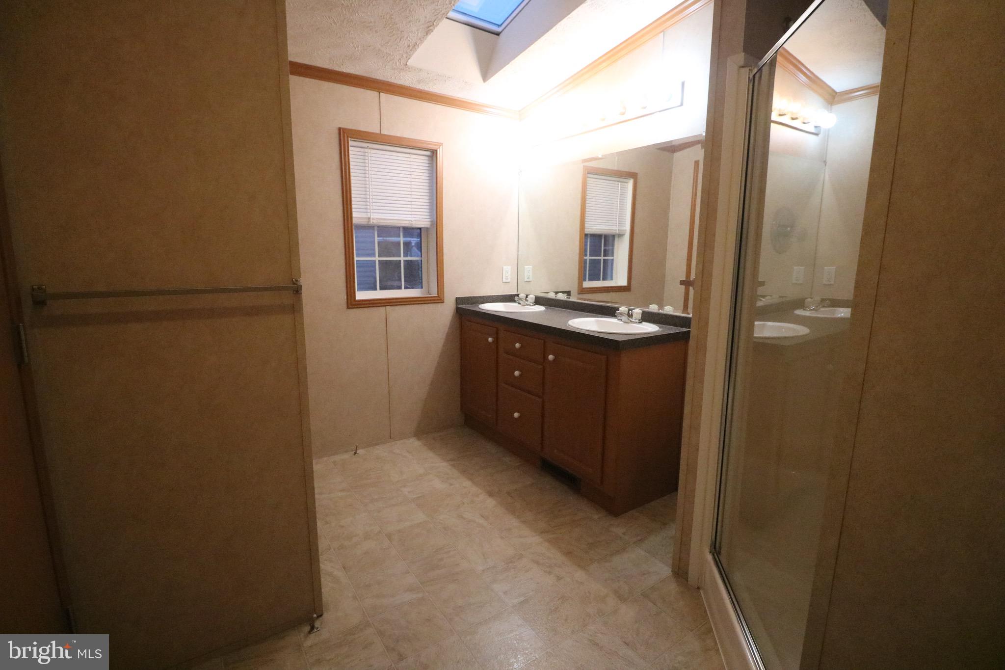118 Conestoga Road Middle River, MD 21220 - Photo 24 of 38 a bathroom with a granite countertop sink a mirror and a refrigerator