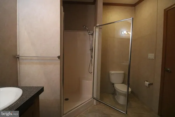 a bathroom with a granite countertop shower
