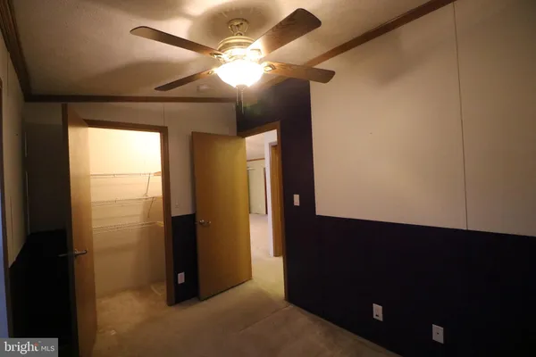 a view of a hallway with a refrigerator and a window