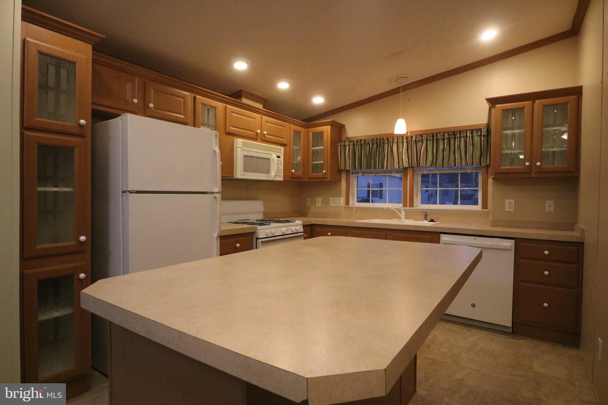 118 Conestoga Road Middle River, MD 21220 - Photo 6 of 38 a kitchen with a refrigerator a sink and cabinets