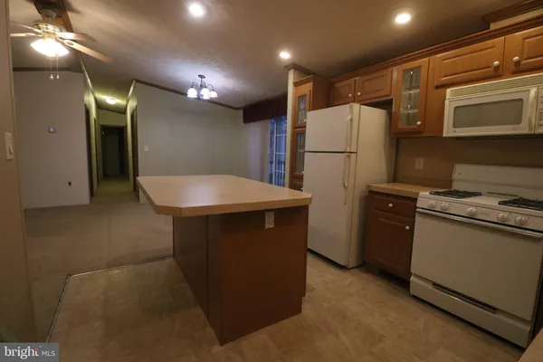 a kitchen with refrigerator and microwave