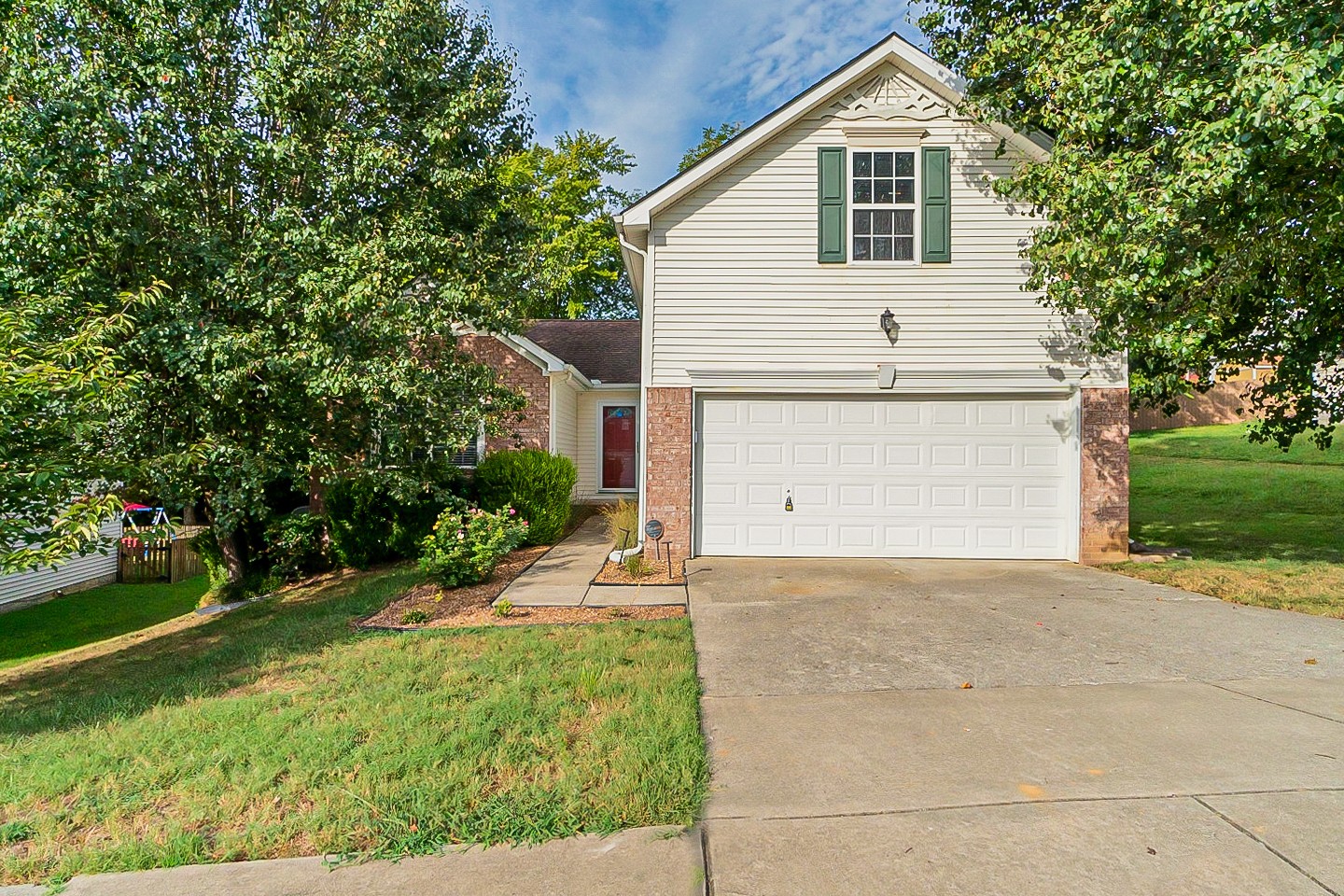 1604 Comanche Run Madison, TN 37115 - Photo 1 of 32 a view of a white house with a yard and garage