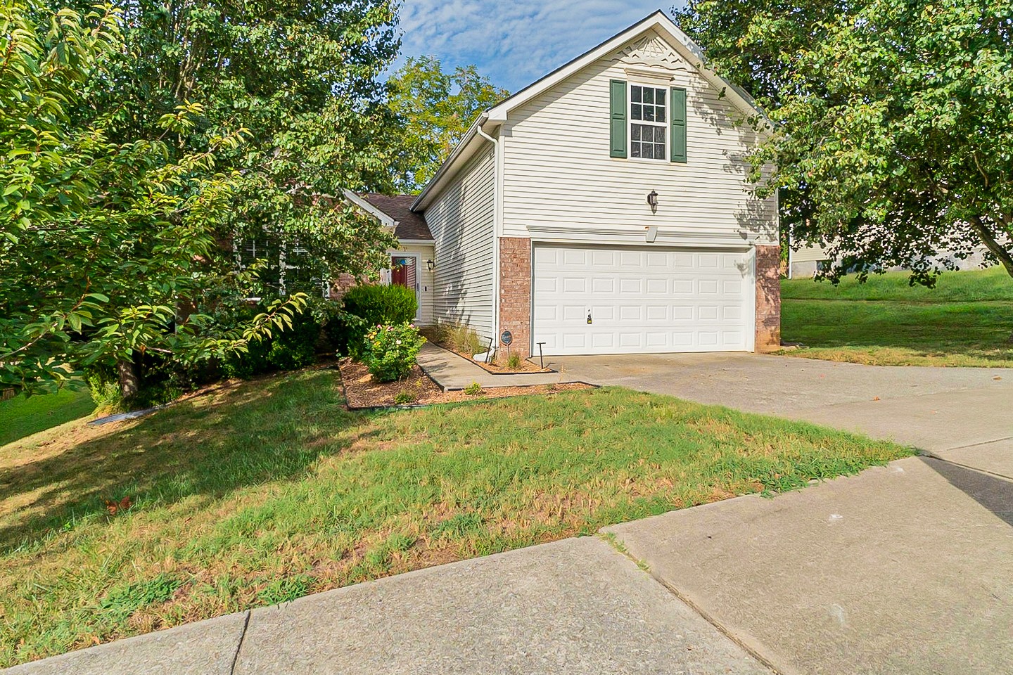 1604 Comanche Run Madison, TN 37115 - Photo 32 of 32 a view of a white house with a big yard and potted plants