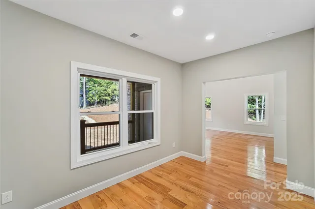 a spacious bathroom with a double vanity sink a mirror and a bathtub