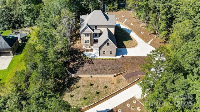 a view of a house with a yard and sitting area