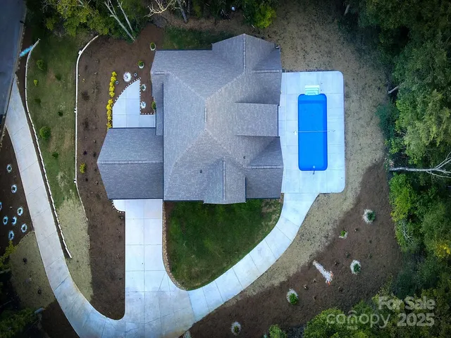 an aerial view of a house with garden space ocean view