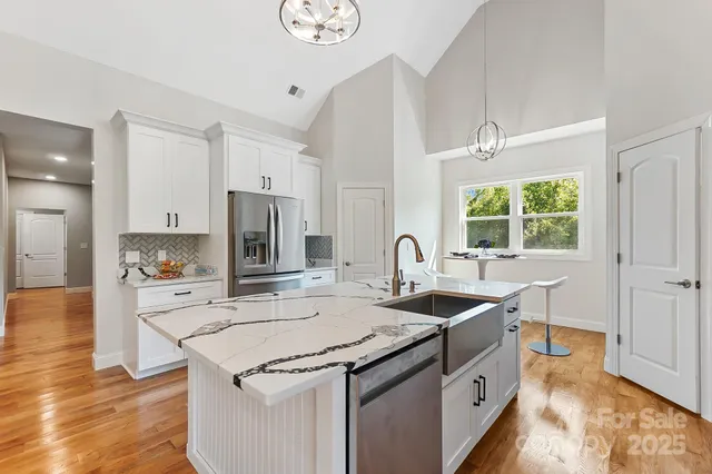 a kitchen that has a sink and a stove in it