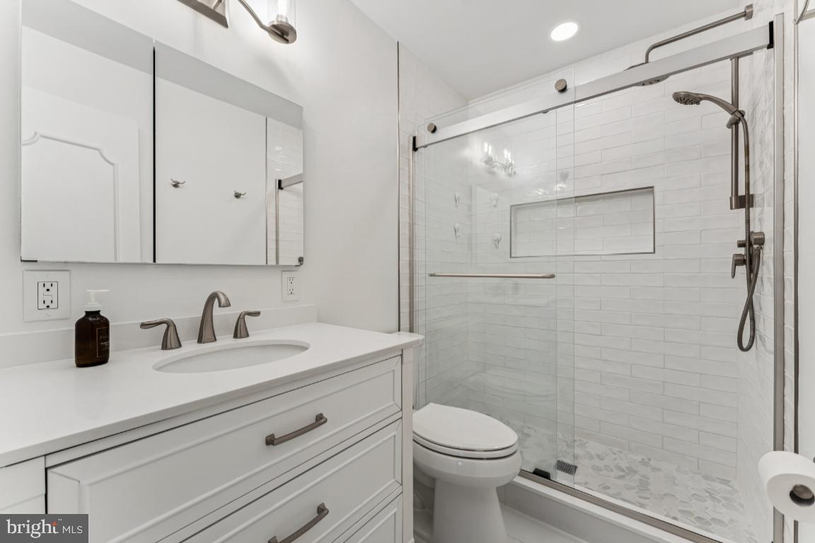 3559 Hamlet Place Chevy Chase, MD 20815 - Photo 11 of 26 a bathroom with a sink a toilet and shower