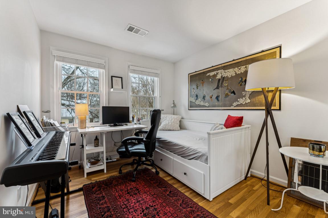 3559 Hamlet Place Chevy Chase, MD 20815 - Photo 13 of 26 a living room with furniture a desk and chair with the floor to ceiling window