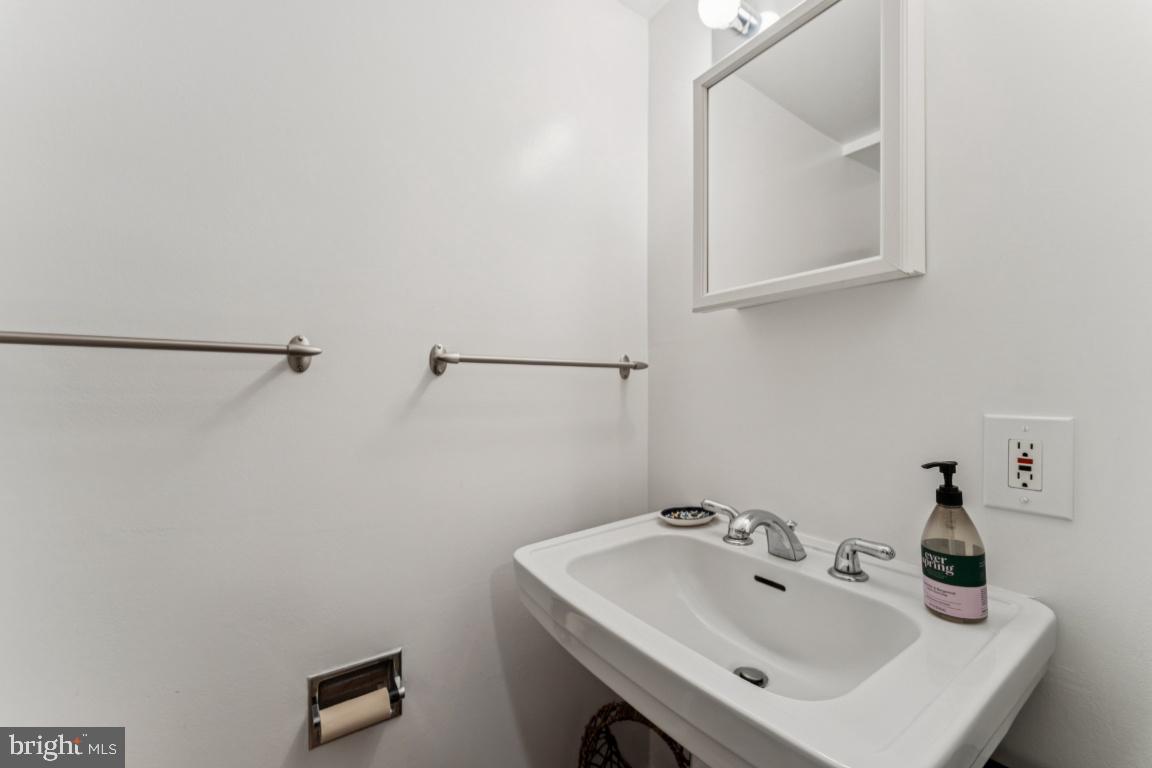 3559 Hamlet Place Chevy Chase, MD 20815 - Photo 17 of 26 a bathroom with a sink and a mirror