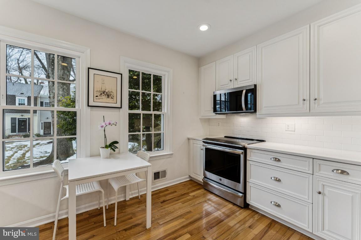 3559 Hamlet Place Chevy Chase, MD 20815 - Photo 4 of 26 a kitchen with stainless steel appliances kitchen island granite countertop a stove and a sink