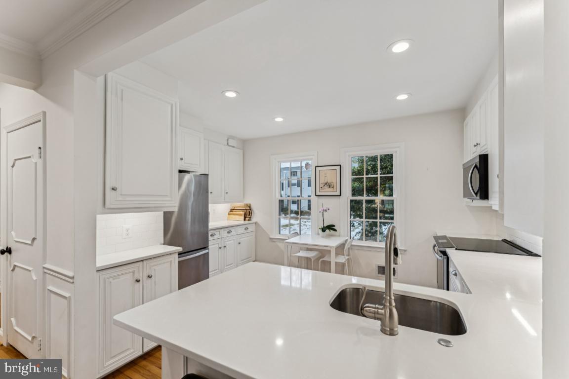 3559 Hamlet Place Chevy Chase, MD 20815 - Photo 5 of 26 a kitchen with stainless steel appliances a sink stove and refrigerator