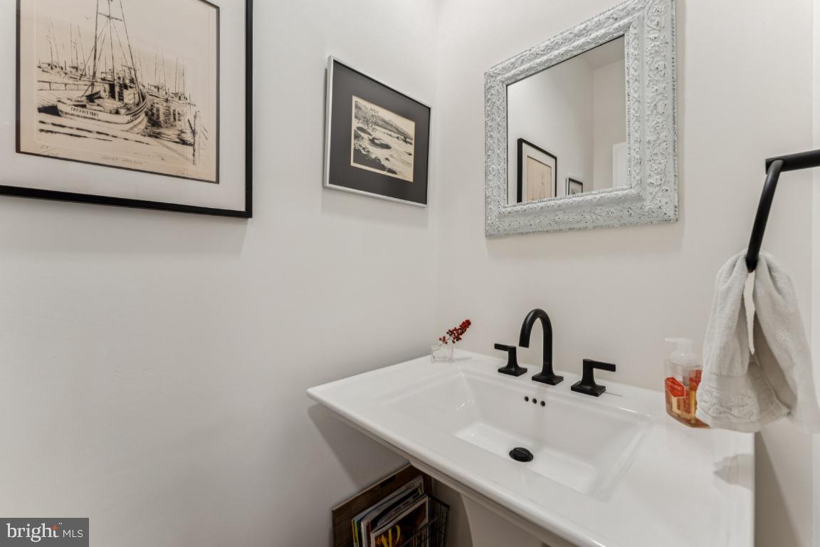 3559 Hamlet Place Chevy Chase, MD 20815 - Photo 9 of 26 a bathroom with a sink and a mirror