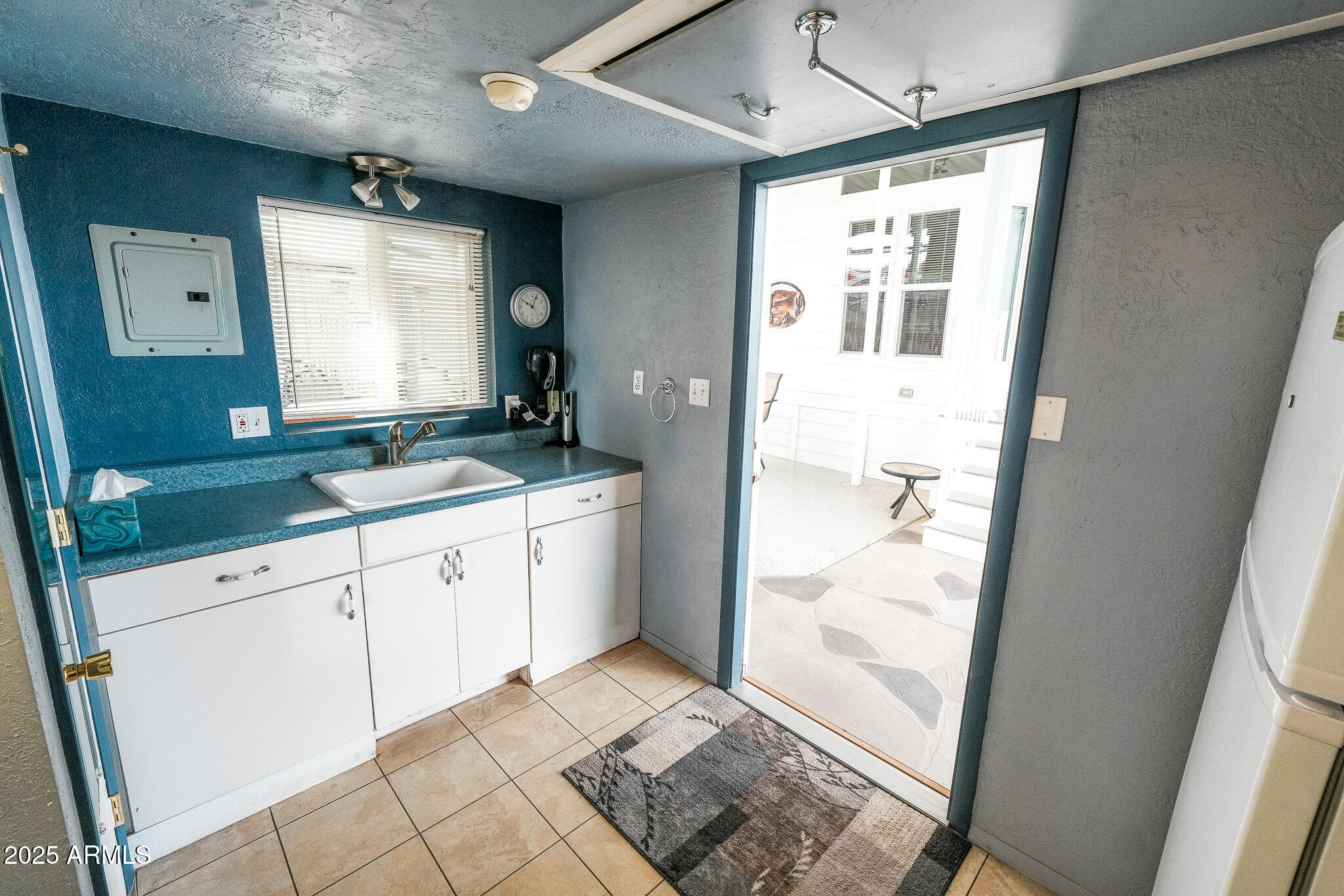 17200 West Bell Road, Unit 915 Surprise, AZ 85374 - Photo 14 of 32 a kitchen with granite countertop white cabinets and white appliances