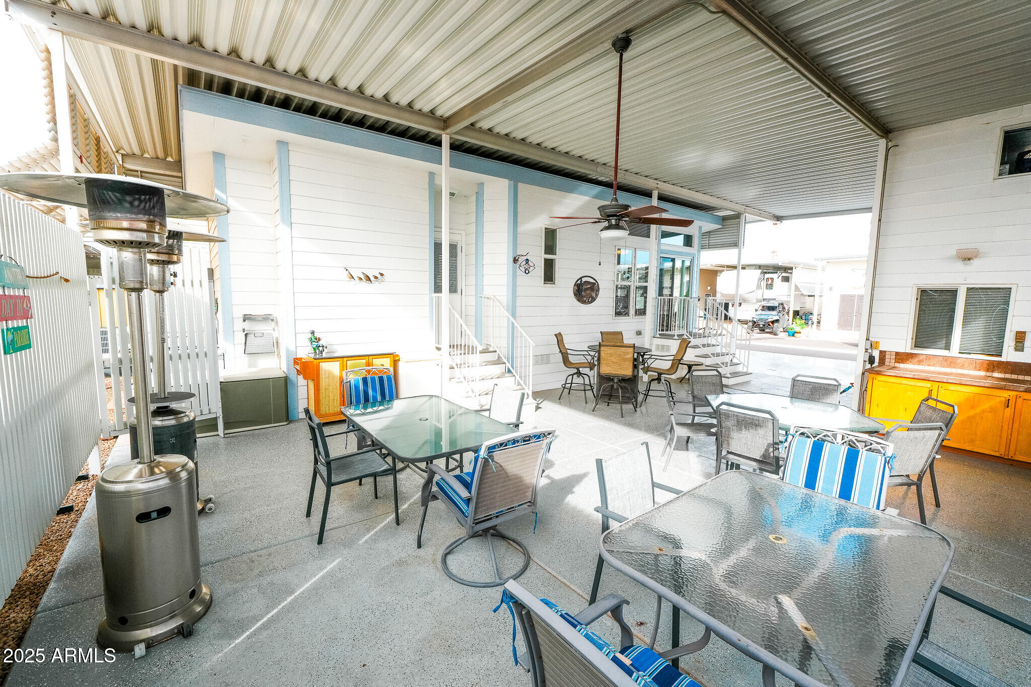 17200 West Bell Road, Unit 915 Surprise, AZ 85374 - Photo 18 of 32 a view of a dining room with furniture a chandelier and wooden floor