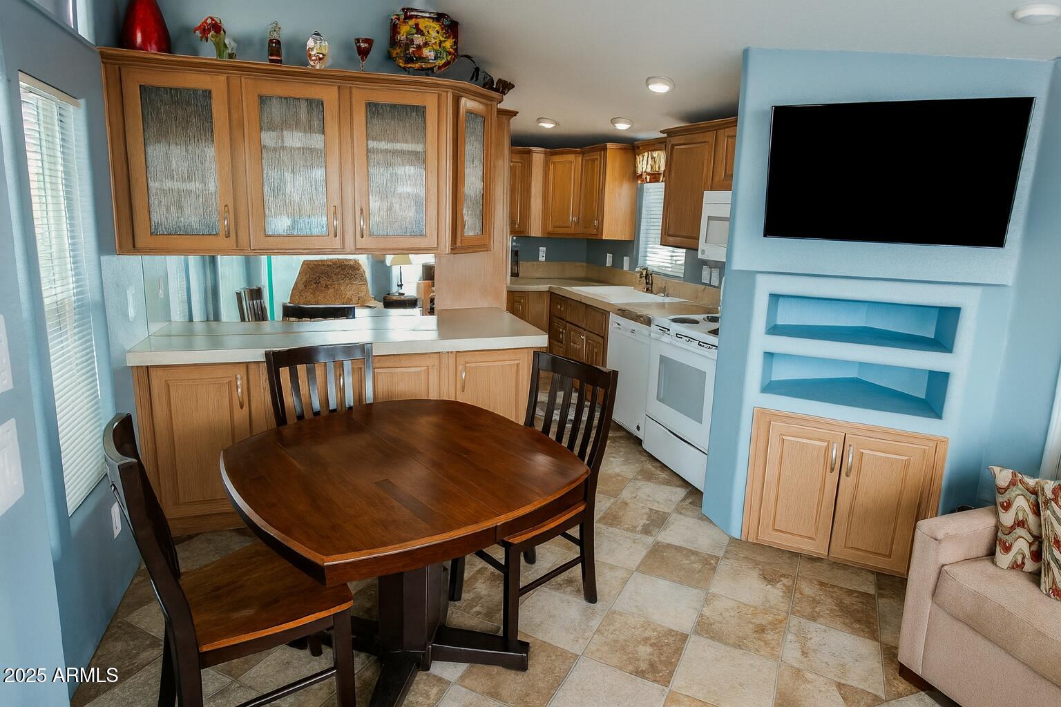 17200 West Bell Road, Unit 915 Surprise, AZ 85374 - Photo 22 of 32 a kitchen with a table chairs sink and cabinets