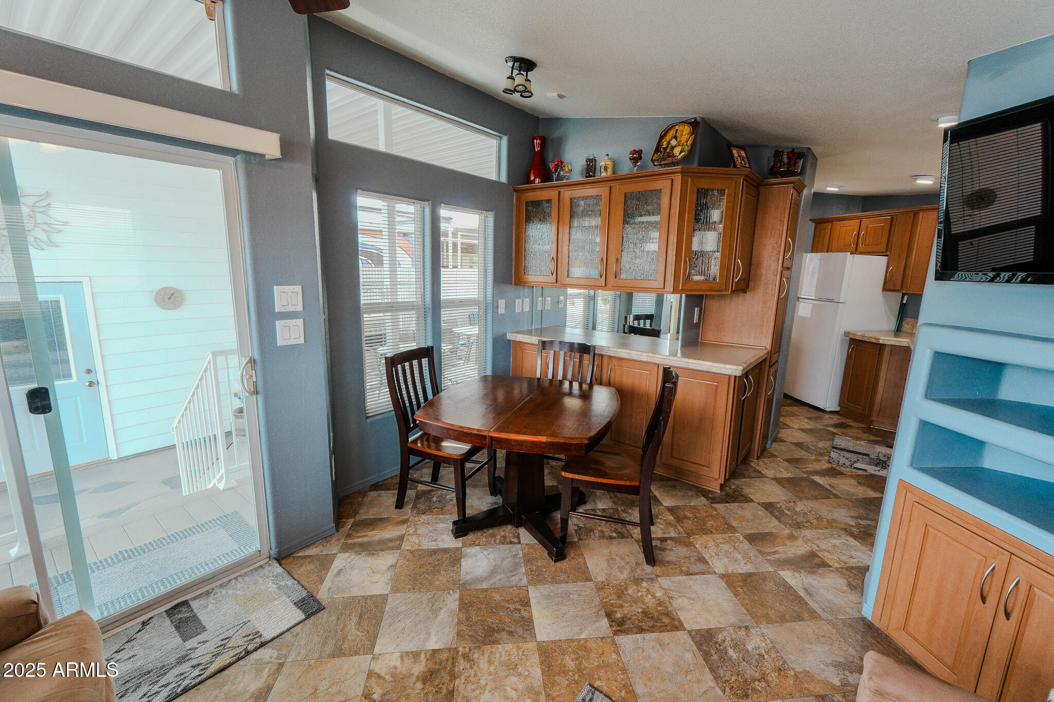 17200 West Bell Road, Unit 915 Surprise, AZ 85374 - Photo 23 of 32 a view of a dining room with furniture window and wooden floor