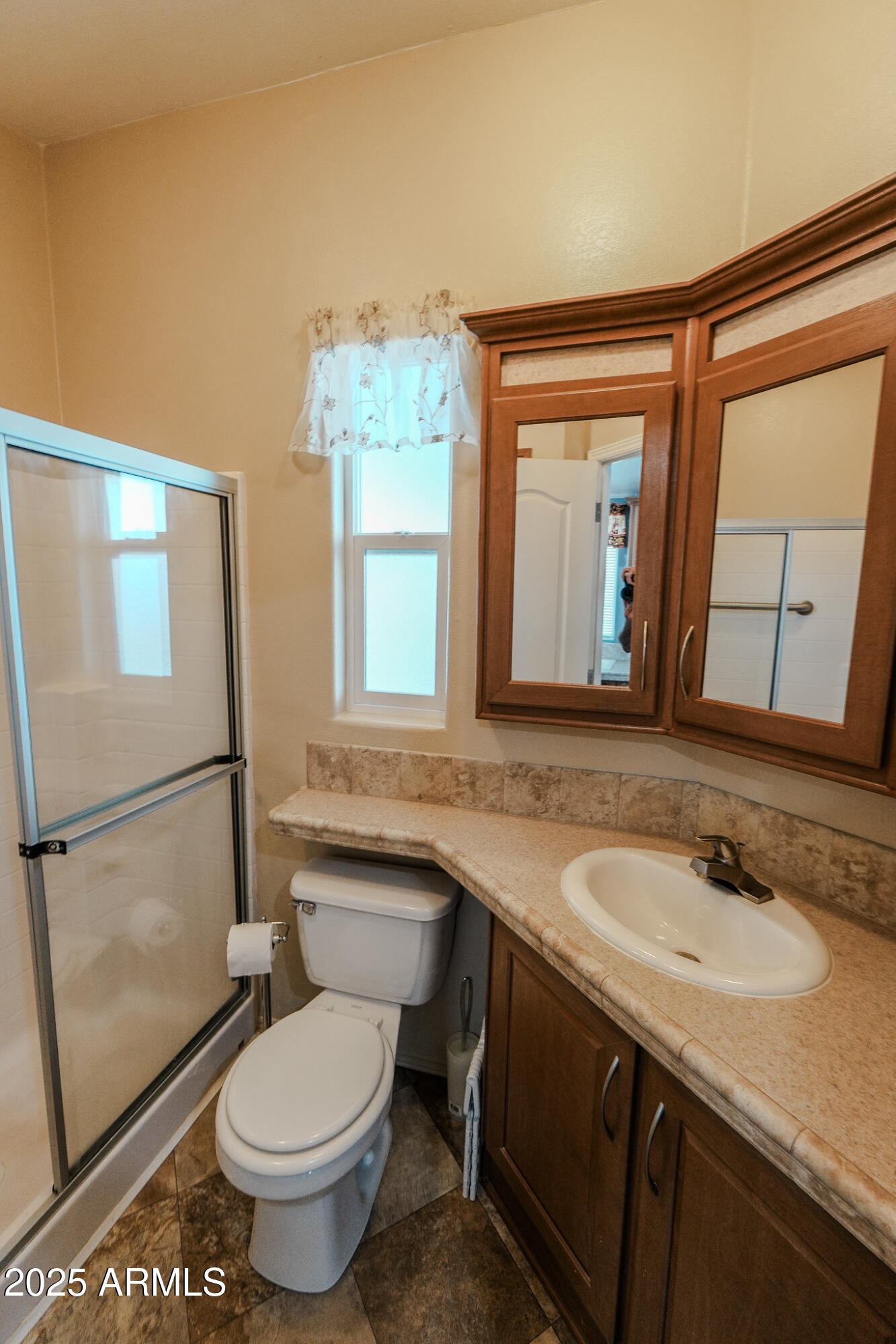 17200 West Bell Road, Unit 915 Surprise, AZ 85374 - Photo 26 of 32 a bathroom with a granite countertop sink toilet and shower