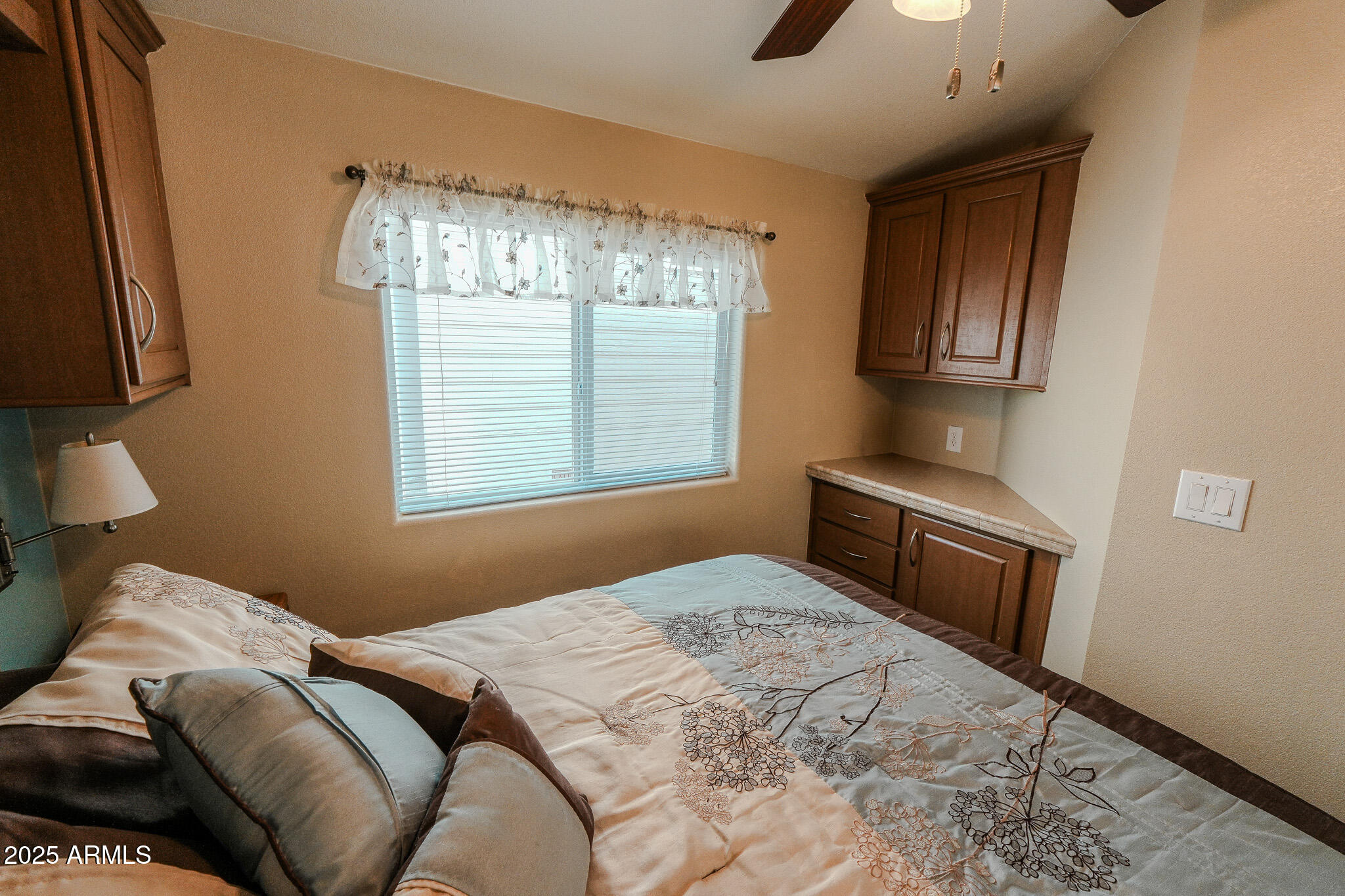 17200 West Bell Road, Unit 915 Surprise, AZ 85374 - Photo 29 of 32 a bedroom with a bed and a chandelier